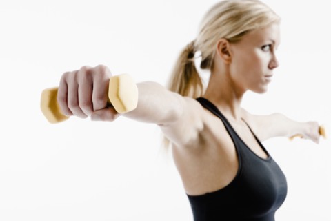 Caucasian woman exercising with hand weights
