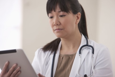 Asian doctor using digital tablet