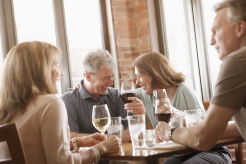 Caucasian friends drinking wine in restaurant