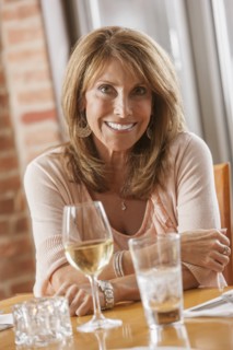 Caucasian woman drinking wine in restaurant