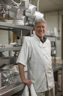 Caucasian chef standing in commercial kitchen