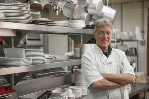 Caucasian chef standing in commercial kitchen