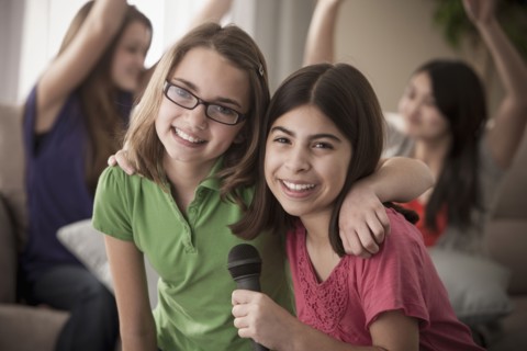 Friends singing karaoke together