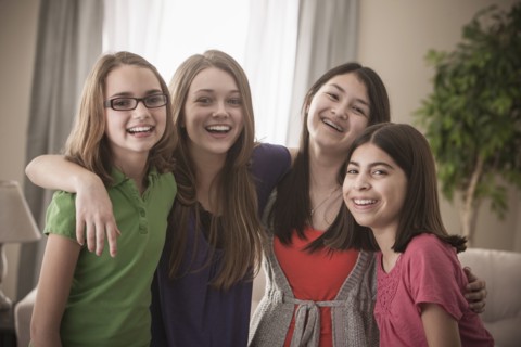 Grinning friends hugging