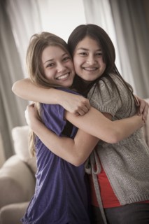 Smiling friends hugging