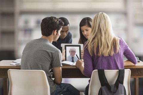 Friends studying together using digital tablet