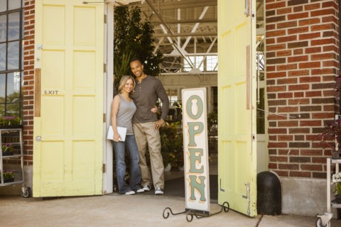 Couple standing in flower shop doorway