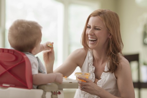 Caucasian mother feeding son