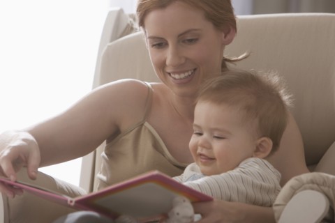 Caucasian mother reading book to son