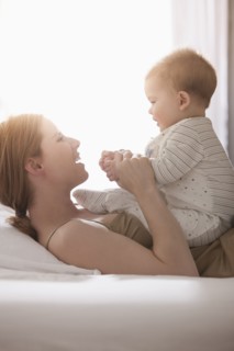 Caucasian mother playing with son