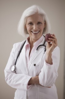 Caucasian doctor holding red apple