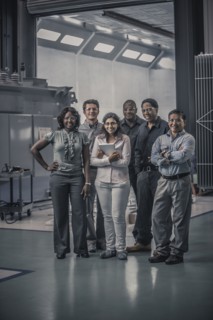 Workers standing together in factory