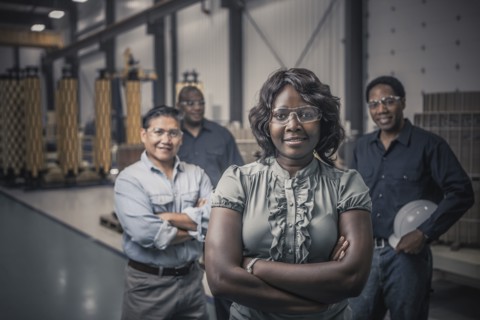 Workers standing together in factory