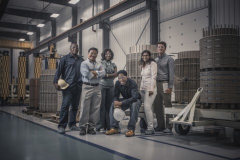 Workers standing together in factory