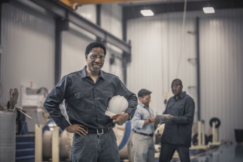 African American worker standing in factory