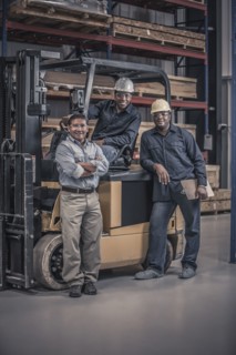 Workers with forklift in factory