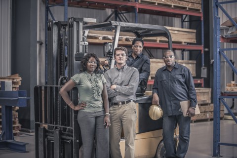 Workers with forklift in factory