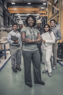 Workers standing together in factory