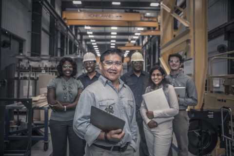 Workers standing together in factory