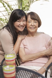 Asian mother and daughter hugging