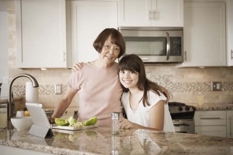Grandmother and granddaughter preparing food