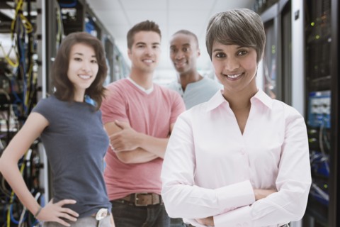 Business people standing in server room