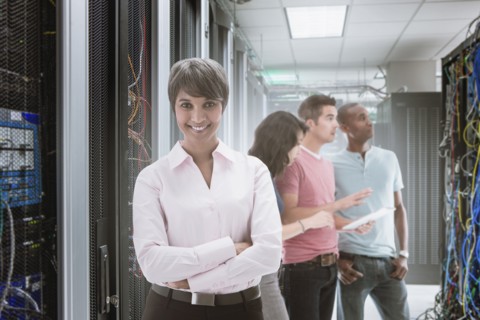 Business people standing in server room