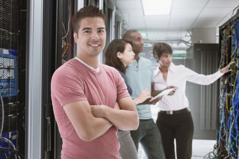 Business people standing in server room