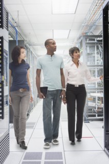 Business people working in server room