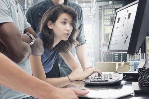 Business people working in server room