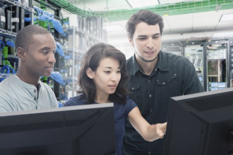 Business people working in server room