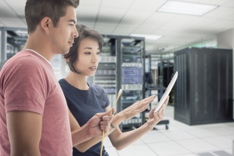 Business people working in server room