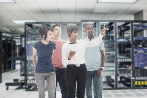 Business people working in server room
