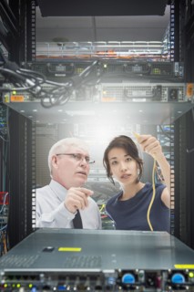 Business people working in server room