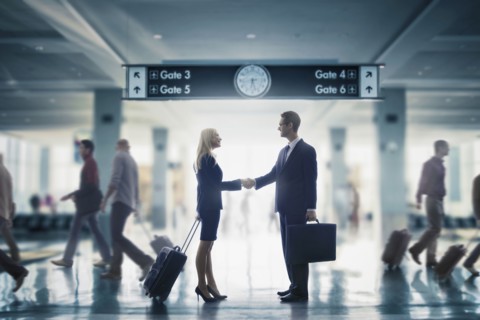Business people shaking hands in airport