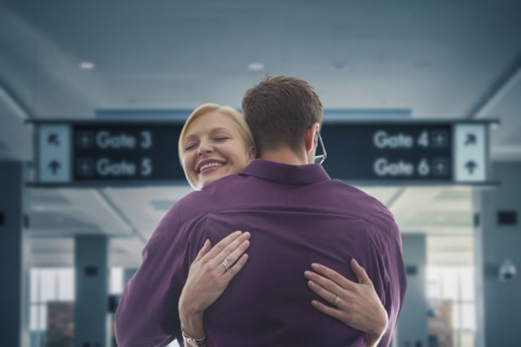 Caucasian hugging in airport