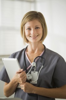 Caucasian nurse holding digital tablet