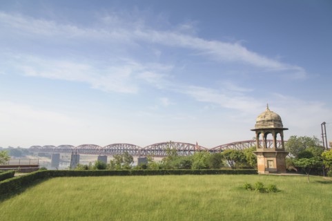 Green park and bridge under blue sky