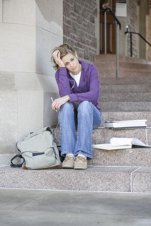 Caucasian student sitting on campus