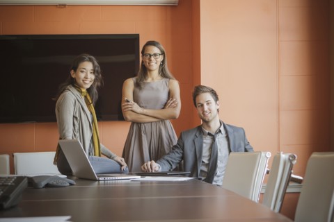Businesspeople smiling in meeting