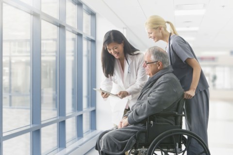 Doctor and nurse talking to patient in hospital