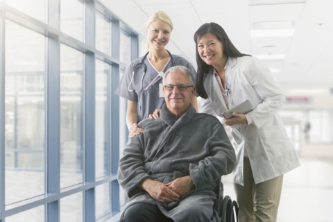 Doctor and nurse smiling with patient in hospital