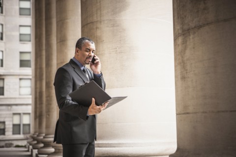 Mixed race businessman talking on cell phone
