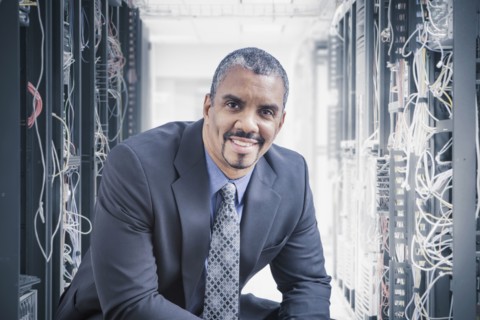 Mixed race businessman sitting in server room