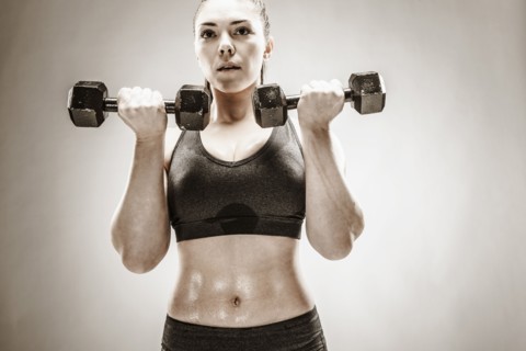 Caucasian woman lifting weights