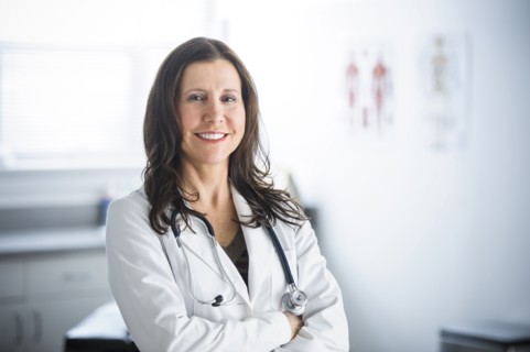 Caucasian doctor smiling in office