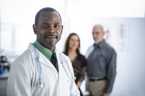 Doctor and patients standing in office