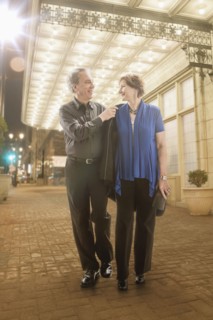 Caucasian couple walking on city street