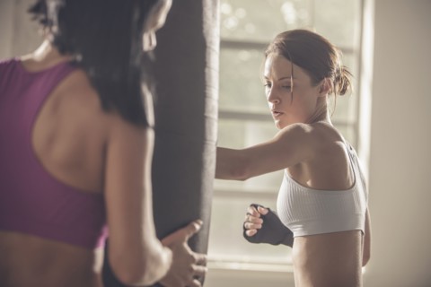 Woman working with trainer in gym
