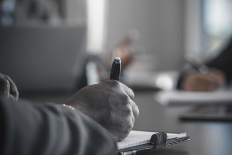 Businessman taking notes in meeting
